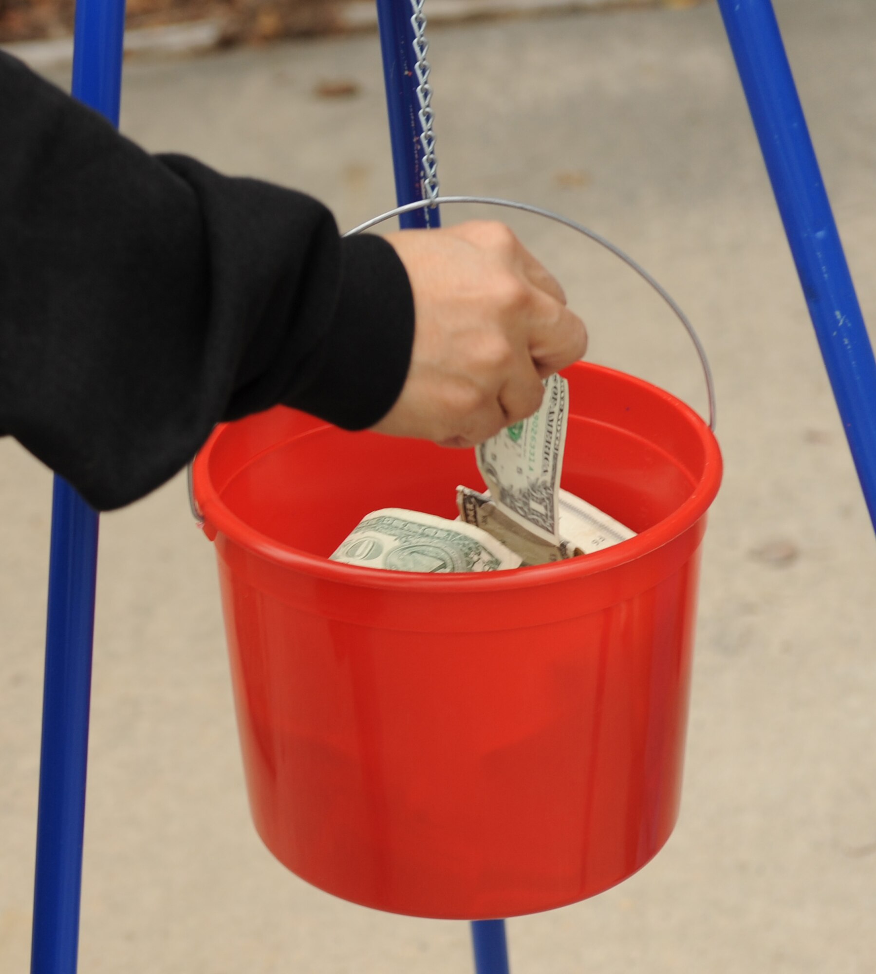 MOODY AIR FORCE BASE, Ga. -- A member of the Moody community donates money during the Ring-a-Bell program hosted by the Moody First Sergeant’s Association here Dec. 11. Collected donations will be used to assist needy families at Moody during the holiday season. (U.S. Air Force photo by Airman 1st Class Benjamin Wiseman)