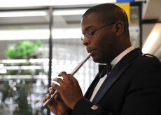 Tech. Sgt. Joshua Gates plays the Irish Penny Whistle during a visit here Dec. 10. Sergeant Gates is with the Heritage Aire ensemble, a component of the U.S. Air Force Heritage of American Band that incorporates Celtic music into their performances. Sergeant Gates is a member of the U.S. Air Force Heritage of America Band. (U.S. Air Force photo/Senior Airman Katie Gieratz)