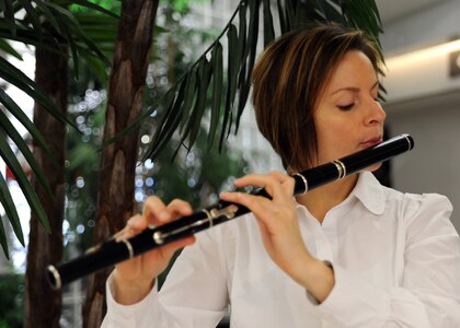 Tech. Sgt. Sherry Burt plays the Irish flute during a visit here Dec. 10. The Heritage Aire played arrangements of traditional Christmas Carols in Celtic style and traditional Celtic carols at their 11 stops on Charleston AFB. Sergeant Burt is the NCOIC of Heritage Aire. (U.S. Air Force photo/Senior Airman Katie Gieratz)(RELEASED)


