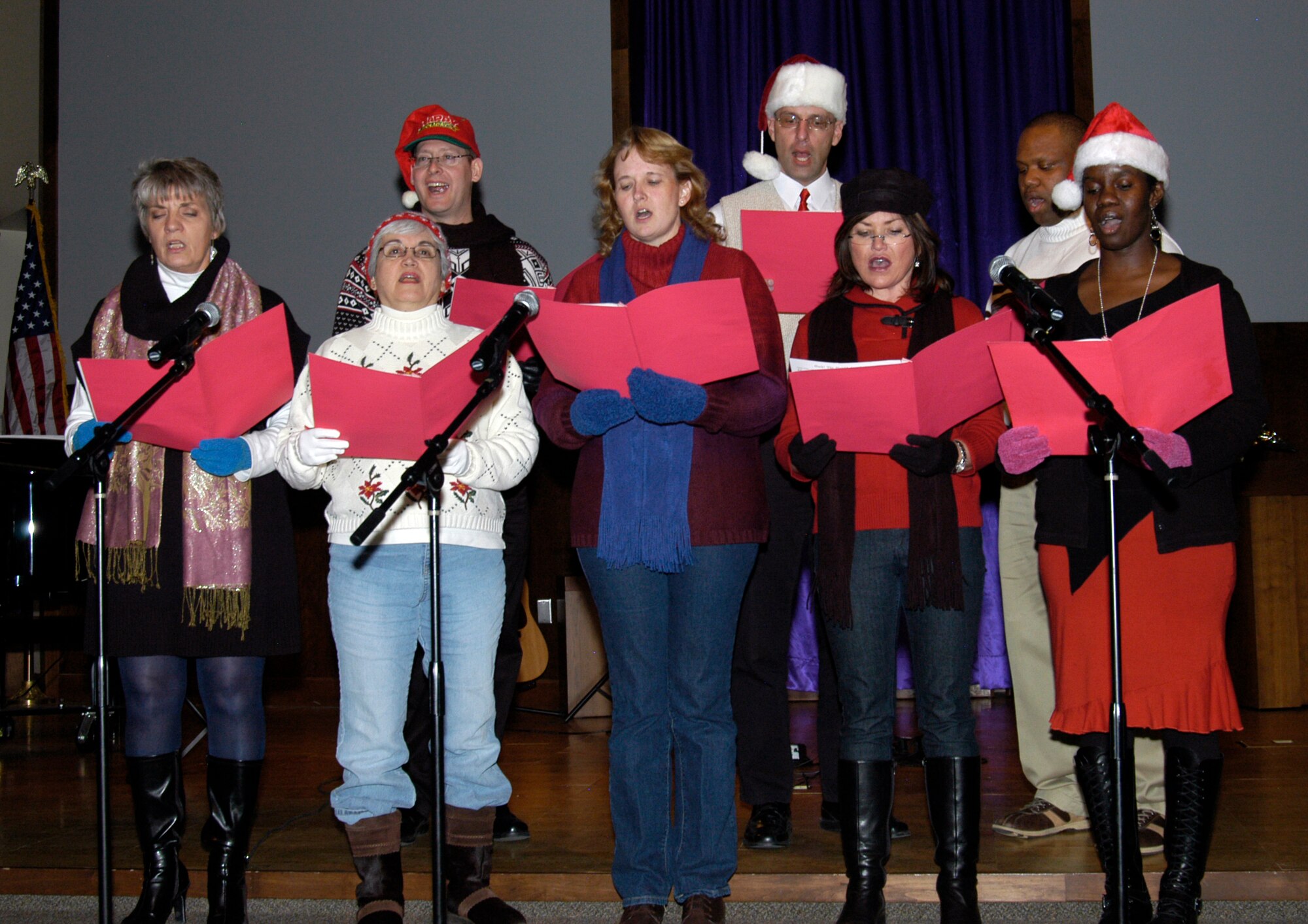 Members of the Air Reserve Personnel Center choir perform during the first annual Songfest at the Buckley Air Force Base chapel on Dec. 13. The event was sponsored by the Buckley Spouses Group and featured 16 performances by Team Buckley singing groups and soloists. Members are: (from left, first row) Melody Mohigh, contract employee ; Viginia Ostendorf, contract employee ; Master Sgt. Barbara Jackson, DPS; Master Sgt. Shari Gevert, DPS; Aretha Cannon, DPP; (back row) Senior Master Sgt. Mark Heath, ARPC first sergeant; Maj. Paul Hubenthal, DPX; and Master Sgt. Eric Evans, DPS. (U.S. Air Force photo/Mike Molina)                               