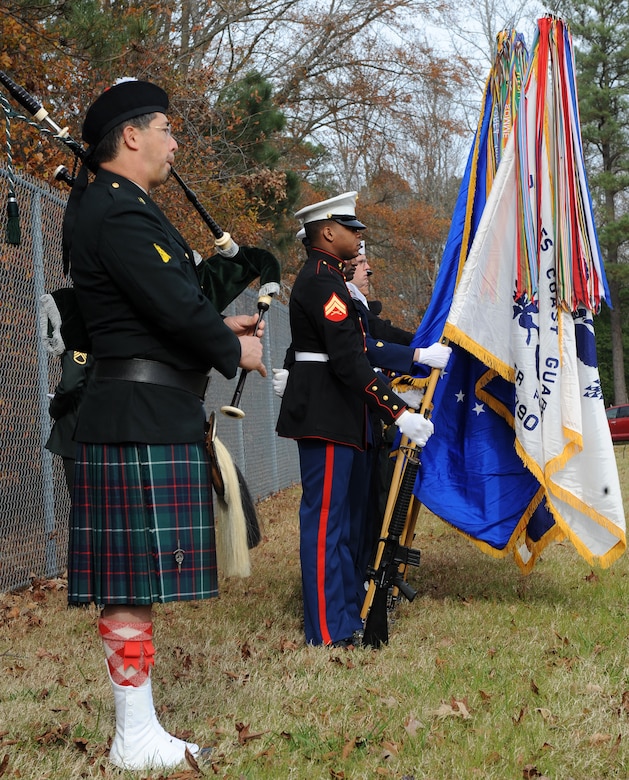 SUFFOLK, Va. -- Bagpiper David Lotz plays "Amazing Grace" while a joint forces honor guard stands at parade rest during the Wreaths Across America ceremony Dec. 12.  Military personnel and the local community laid 2,250 wreaths on the headstones of fallen veterans.  (U.S. Air Force photo/Senior Airman Zachary Wolf)


