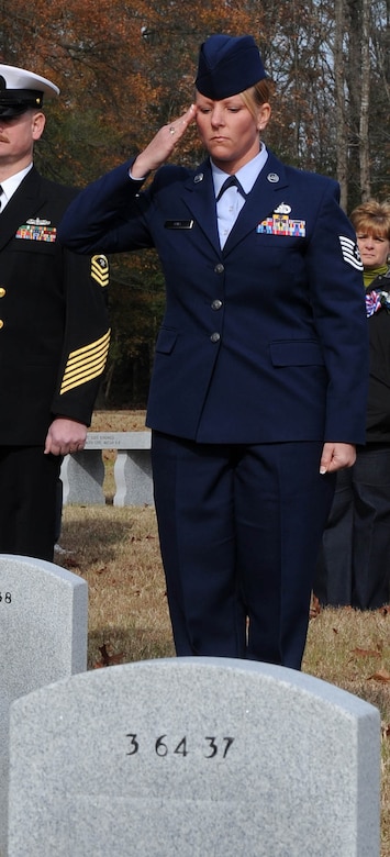 SUFFOLK, Va. -- Tech. Sgt. Pam Krill, 735th Supply Chain Management Group A-10 Weapon Systems manager, salutes the resting place of a veteran, after laying a wreath during the Wreaths Across America ceremony Dec. 12.  Military personnel and the local community laid 2,250 wreaths on the headstones of fallen veterans.  (U.S. Air Force photo/Senior Airman Zachary Wolf)
