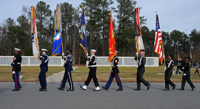 SUFFOLK, Va. -- A joint forces honor guard marches toward the last row of resting places to be presented wreaths, during the Wreaths Across America ceremony Dec. 12.  Military personnel and the local community laid 2,250 wreaths on the headstones of fallen veterans.  (U.S. Air Force photo/Senior Airman Zachary Wolf)
