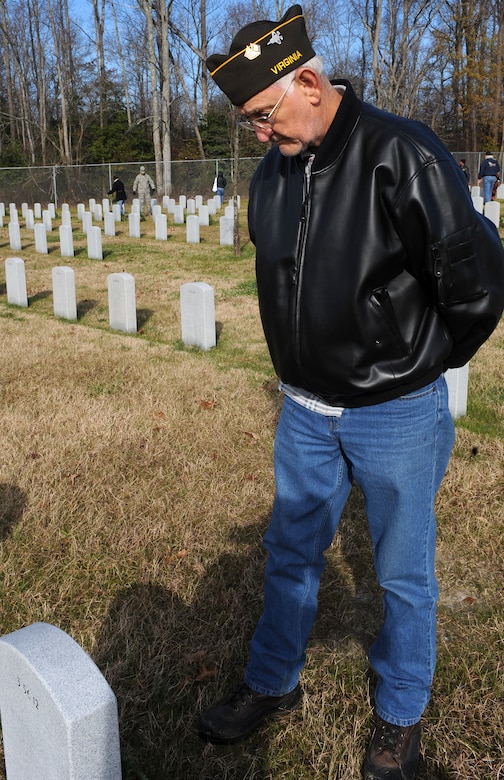 SUFFOLK, Va. -- Retired Navy Chief Petty Officer Duane Ashland pays respects to a fallen veteran, during the Wreaths Across America program Dec. 12.  Military personnel and the local community laid 2,250 wreaths on the headstones of fallen veterans.  (U.S. Air Force photo/Senior Airman Zachary Wolf)
