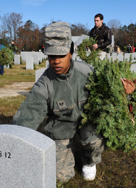 SUFFOLK, Va. -- Staff Sgt. Monique Barnes, 1st Logistics Readiness Squadron vehicle maintenance technician, lays a wreath on a fallen veteran's resting place, during the Wreaths Across America program Dec. 12.  Military personnel and the local community laid 2,250 wreaths on the headstones of fallen veterans.  (U.S. Air Force photo/Senior Airman Zachary Wolf)
