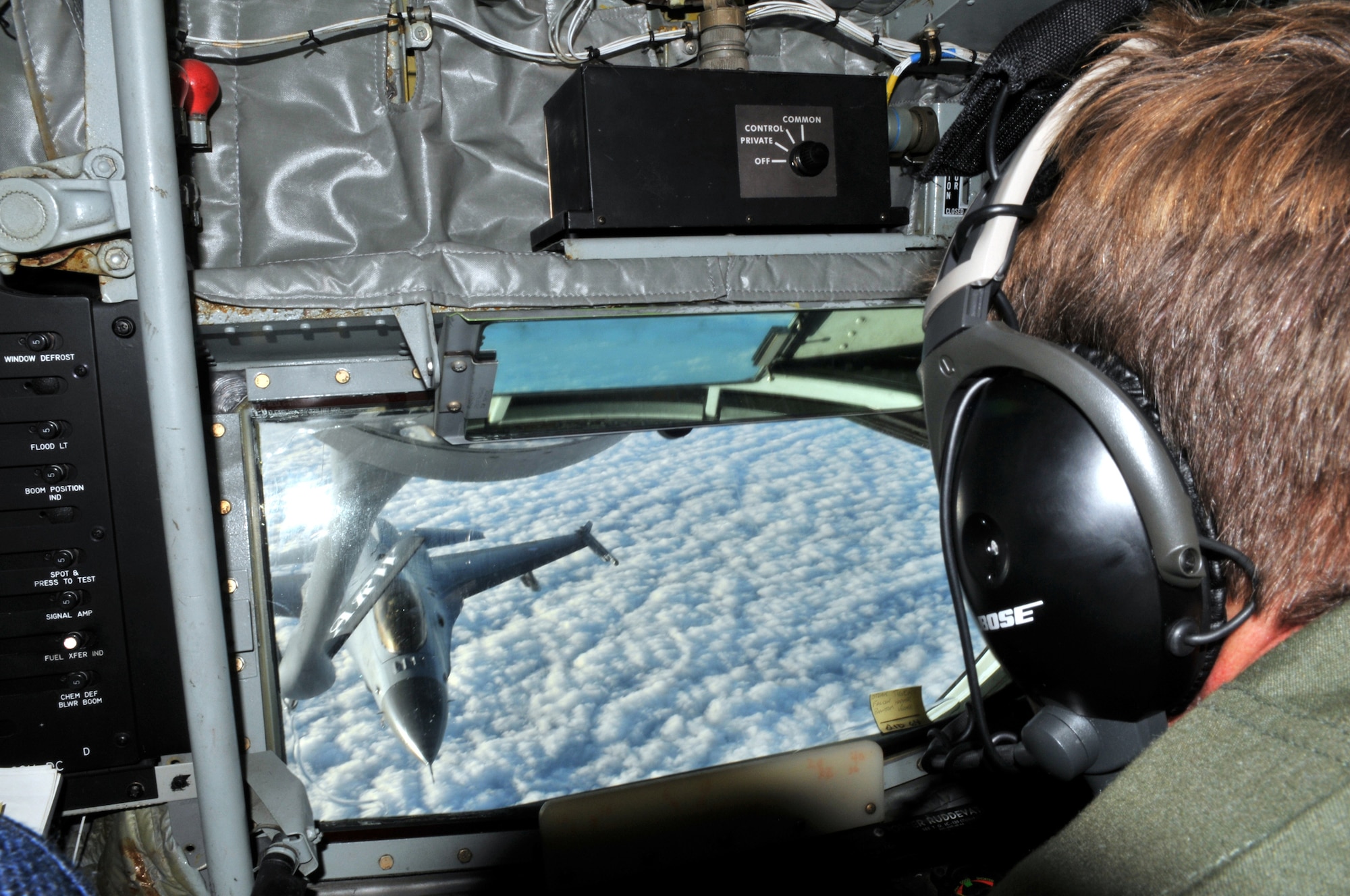 Chief Master Sgt. Christopher Powell guides a KC-135 Stratotanker boom pod as a Royal Danish air force pilot positions a F-16 Fighting Falcon to take on fuel in the skies above Denmark Dec. 8, 2009. The Danish F-16 was one of 30 performing their semi-annual aerial refueling training. Chief Powell is a 100th Operations Group boom operator. (U.S. Air Force photo/Tech. Sgt. Kevin Wallace)