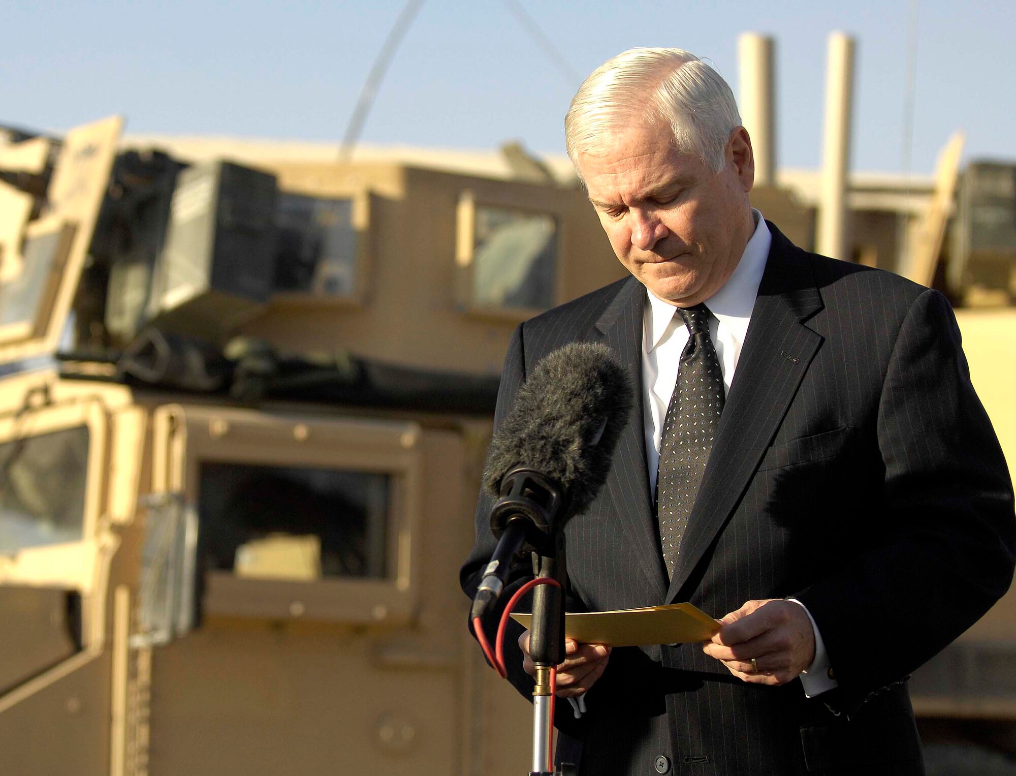 Secretary of Defense Robert M. Gates looks over his notes as he talks with members of the press on Kandahar Air Field, Afghanistan, Dec. 11, 2008. Secretary Gates addressed more than 300 Airmen and Soldiers Dec. 11, 2009 at Kirkuk Regional Air Base, Iraq. (DoD photo by Tech. Sgt. Jerry Morrison, U.S. Air Force/Released)
