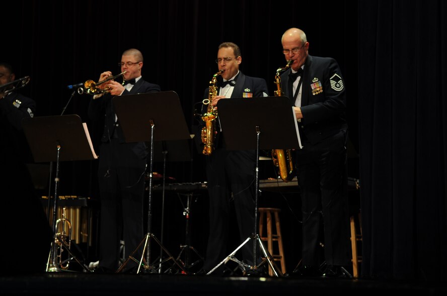 Airman 1st Class Jon Virtue, trumpet, Staff Sgt. Chris Stelling, alto saxophone, and Master Sgt. Al Wittig, tenor saxophone, perform with "Satellite," one of the featured ensembles of the United States Air Force Heritage of America Band's holiday concert at Goldsboro High School, N.C., Dec. 7, 2009. Consisting of several unique musical ensembles, the Heritage of America Band performs for more than one million people throughout a six-state region from Pennsylvania to South Carolina each year.  Airman Virtue is originally from Collegeville, Pa., Sergeant Stelling hails from Kearney, Neb., and Sergeant Wittig is a Cleveland native. (U.S. Air Force photo/Staff Sgt. Courtney Richardson)