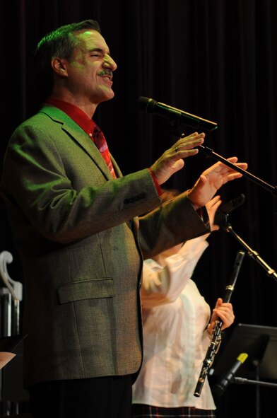 Mr. Mark Bzdick, guest vocalist and narrator, sings "Cantique de Noel" during the United States Air Force Heritage of America Band's holiday concert at Goldsboro High School, N.C., Dec. 7, 2009. "Cantique de Noel," commonly known as "O Holy Night," was composed by Adolphe Adam in 1847. Mr. Bzdick grew up in New Hartford, N.Y., and owns the theatre company Soundstage. 