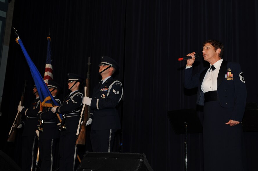 Master Sgt. Verlie Vigil, United States Air Force Heritage of America Band trumpet player, sings the National Anthem during the band's holiday concert at Goldsboro High School, N.C., Dec. 7, 2009. The Heritage of America Band has a long history of entertaining the American public and promoting esprit de corps within the military. Sergeant Vigil is a native of San Francisco. (U.S. Air Force photo/Staff Sgt. Courtney Richardson)