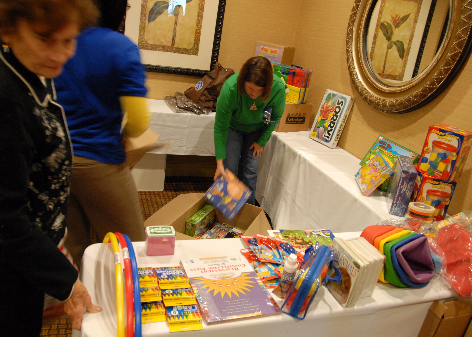 Angela Mandley, spouse of Capt. Michael Mandley, 919th Communications Squadron, loads up toys as part of a give-a-way during the local Yellow Ribbon event Dec. 12 held in Fort Walton Beach, Fla.  The Yellow Ribbon program provides reservists and their families the opportunity to learn and prepare for specific issues people face during a deployment cycle.  (U.S. Air Force photo/ Staff Sgt. Samuel King Jr.)