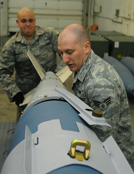 ELLSWORTH AIR FORCE BASE, S.D. -- (Left to right) Airman 1st Class Michael DiRienzo and Senior Airman Justin Reinwand, 28th munitions Squadron conventional maintenance crew members, attach a tail fin to an inert Guided Bomb Unit-31, Dec. 8.  The tail fin adds balance and stability to the GBU-31. (U.S. Air Force photo/Airman 1st Class Anthony Sanchelli)