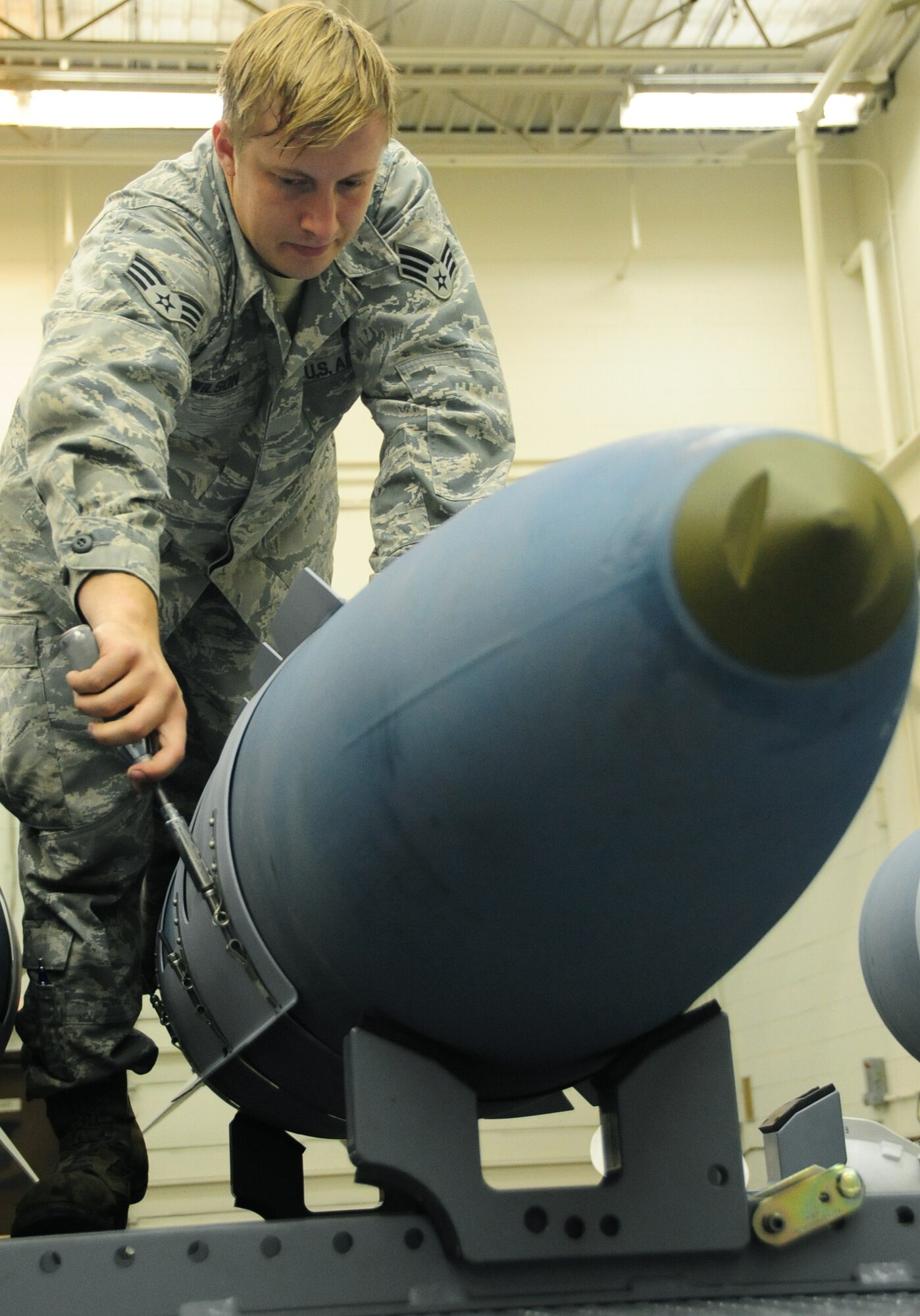 ELLSWORTH AIR FORCE BASE, S.D. -- Senior Airman Myco Wilson, 28th Munitions Squadron conventional maintenance crew member, secures an aerosurface assembly on an inert Guided Bomb Unit-31, Dec. 8.  The aerosurface assembly is designed to stabilize the GBU-31. (U.S. Air Force photo/Airman 1st Class Anthony Sanchelli)





