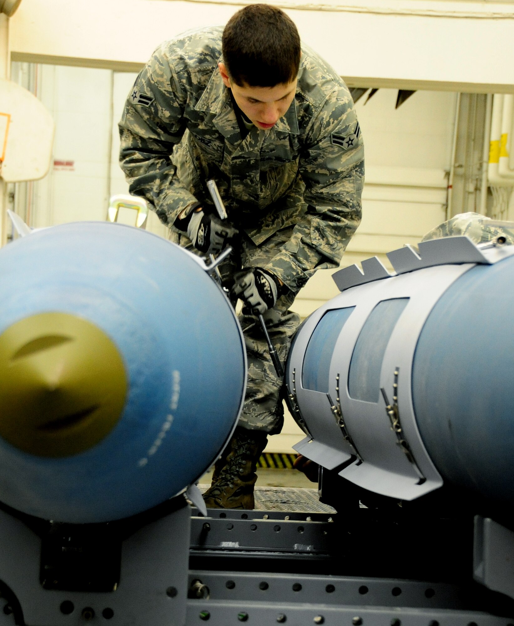 ELLSWORTH AIR FORCE BASE, S.D. -- Airman 1st Class Aaron Valdez, 28th Munitions Squadron conventional maintenance crew member, secures an aerosurface assembly on an inert Guided Bomb Unit-31, Dec. 8.  The aerosurface assembly is designed to stabilize the GBU-31. (U.S. Air Force photo/Airman 1st Class Anthony Sanchelli)



