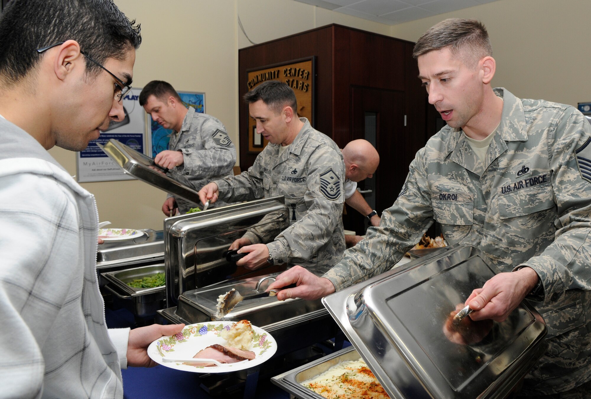 SPANGDAHLEM AIR BASE, Germany – Master Sgt. Samuel Okroi, 52nd Equipment Maintenance Squadron, serves food during the Unaccompanied Airman’s Holiday Party Dec. 11 at the Brick House. The party included food, games and prizes. (U.S. Air Force photo/Airman 1st Class Staci Miller)