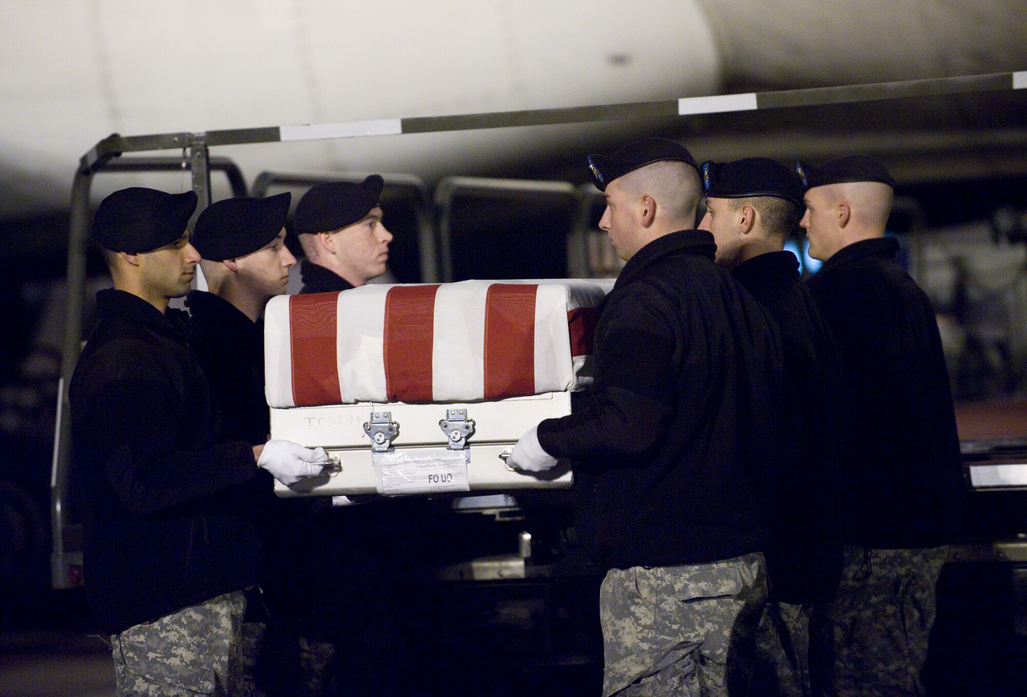 12 December 2009  USAF Photo by Brianne Zimny.  A U.S. Army carry team transfers the remains of Army PFC Jaiciae L Pauley of Austell, GA. at Dover Air Force Base, Del., December 12, 2009.