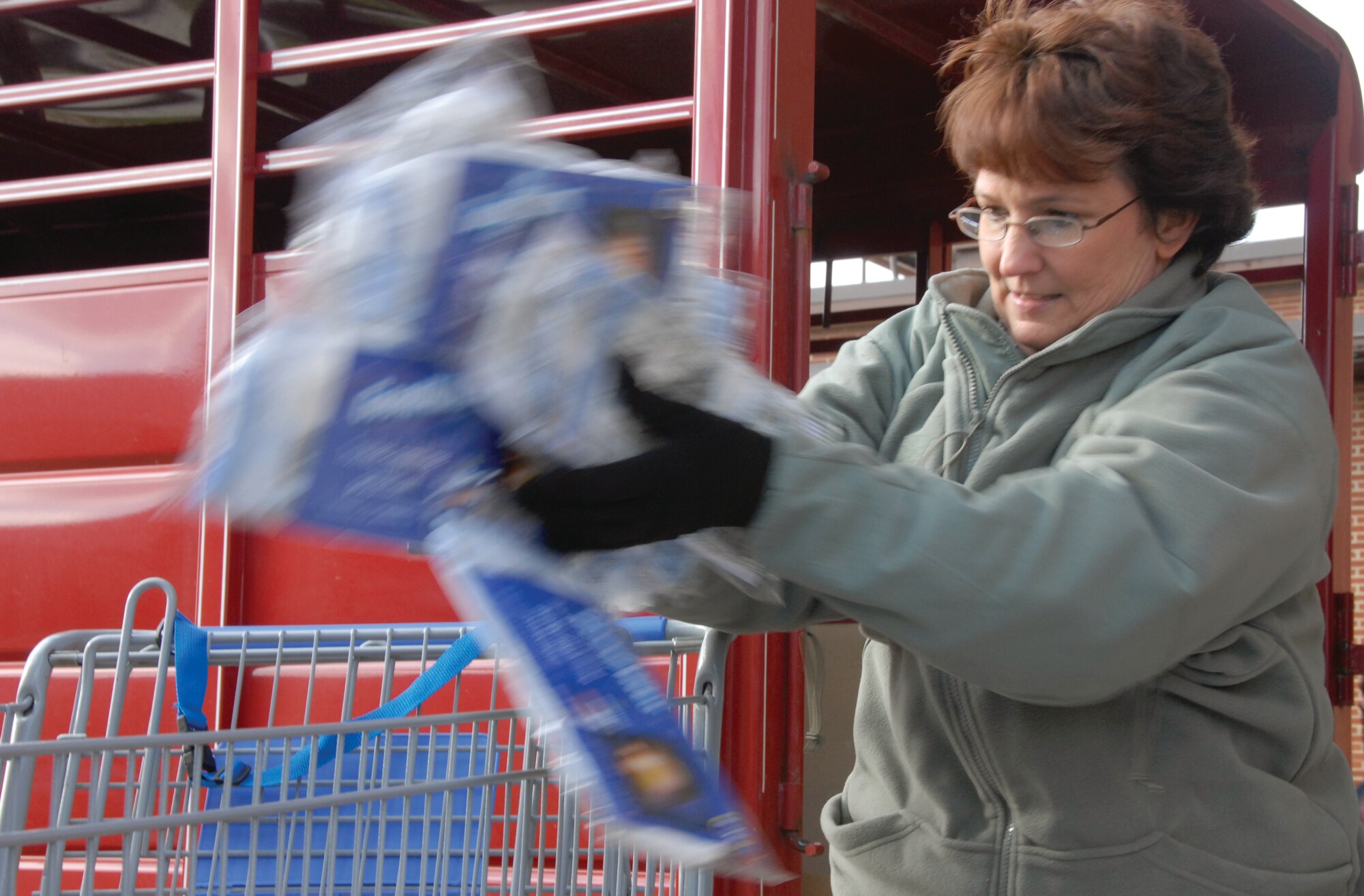Master Sgt. Vickie Chambers puts diapers into a shopping cart while unloading the trailer of donated items for Operation Helping Hand. Sergeant Chambers is the non-comissioned officer in charge of the 442nd Airman and Family Readiness office. The 442nd Fighter Wing is an Air Force Reserve unit at Whiteman Air Force Base, Mo. (U.S. Air Force photo/Senior Airman Danielle Wolf)