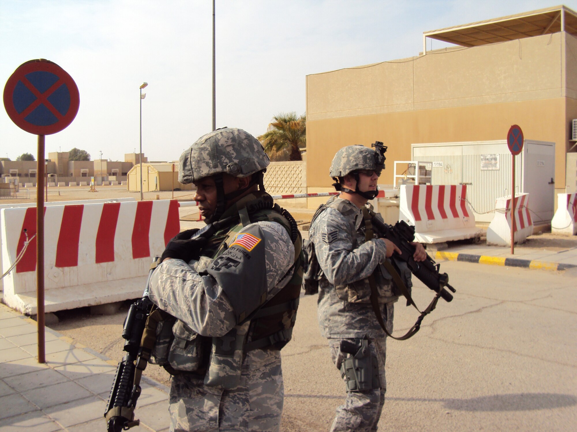 SOUTHWEST ASIA ? Left, Tech. Sgt. James Anderson, 64th Expeditionary Security Forces Squadron base defense operations cell, coordinates the movement of first response personnel as Staff Sgt. Derek Bertram, 64 ESFS, controls traffic during a base-wide exercise at an undisclosed location. The exercise tested both unit readiness and the ability to operate while under attack. Sergeant Anderson is deployed from the District of Colombia Air National Guard and Sergeant Bertram is deployed from the Minnesota Air National Guard; both are deployed in support of operations Iraqi Freedom and Enduring Freedom. (U.S. Air Force photo/Staff Sgt. Kyle Ray) 