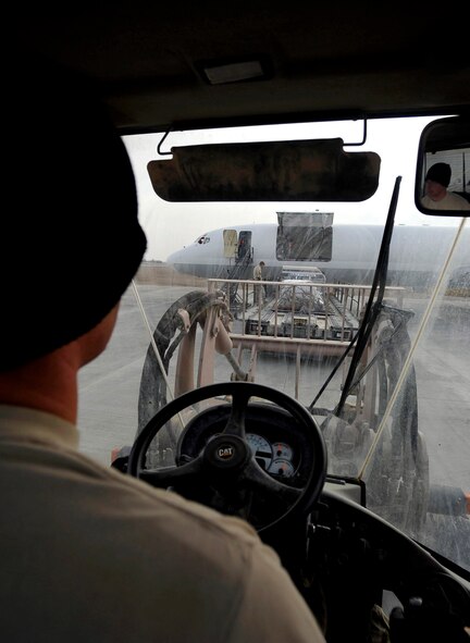 U.S. Air Force Airman 1st Class Joshua McGee, 451st Expeditionary Logistics Readiness Squadron Det. 1 air transportation apprentice stationed at Pope AFB, N.C., deployed to Camp Bastion, Afghanistan, takes pallets off of a 60K loader, Dec. 11, 2009. The 451st ELRS received 18 pallets for the members of Camp Bastion. (U.S. Air Force photo/Staff Sgt. Angelita Lawrence)