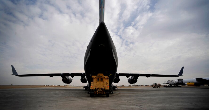 U.S. Air Force Airman 1st Class Joshua McGee, 451st Expeditionary Logistics Readiness Squadron Det. 1 air transportation apprentice stationed at Pope AFB, N.C., deployed to Camp Bastion, Afghanistan, off loads an MRAP from a C-17 Globemaster III, Dec. 11, 2009. New MRAPs will provide safety and security to ground troops during convoy operations. (U.S. Air Force photo/Staff Sgt. Angelita Lawrence)