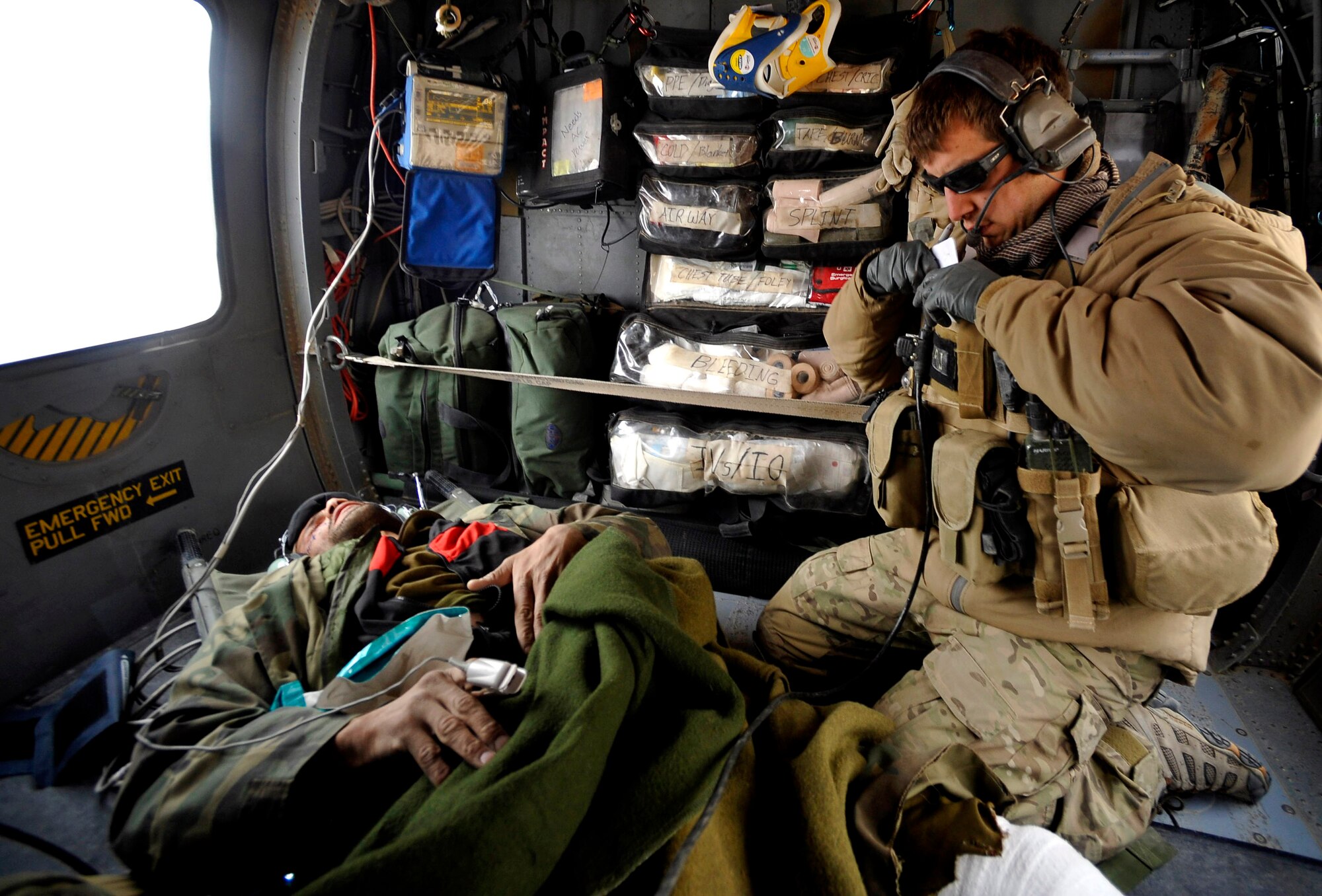 A U.S. Air Force Pararescueman from the 66th Expeditionary Rescue Squadron deployed to Camp Bastion, Afghanistan, provides medical attention to an Afghan who has suffered gunshot injuries, Dec. 8, 2009.  The PJs are able to rescue patients in any situation who need medical attention.  (U.S. Air Force photo/Staff Sgt. Angelita Lawrence)
