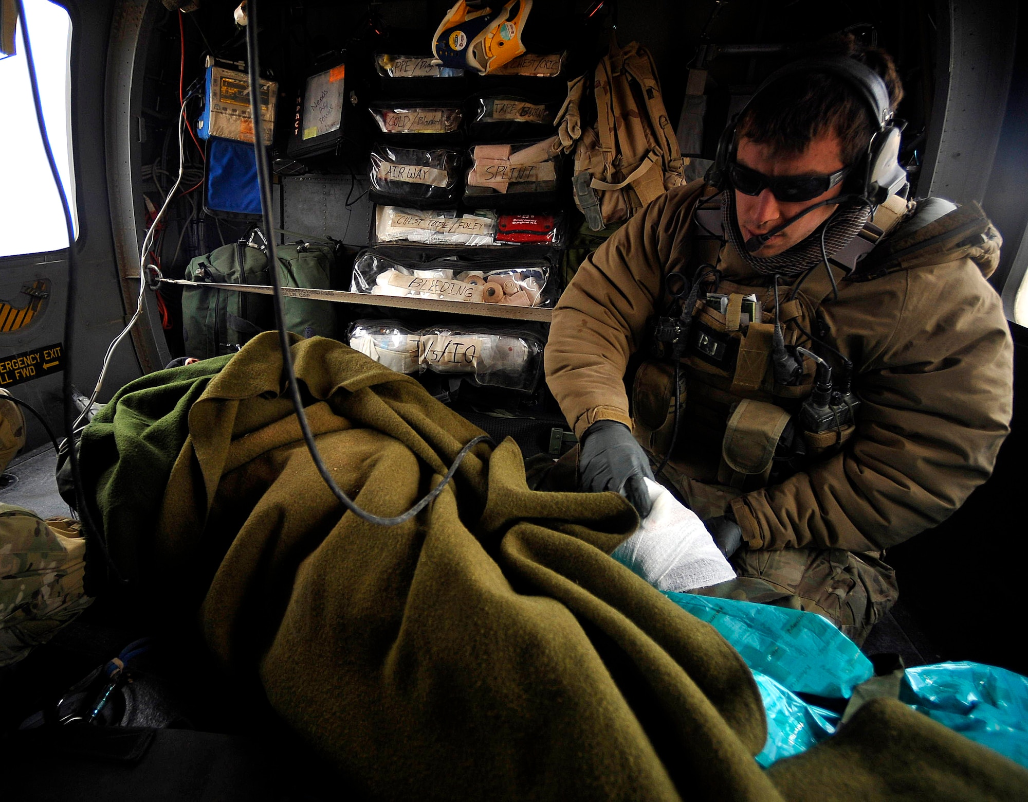 A U.S. Air Force Pararescueman from the 66th Expeditionary Rescue Squadron deployed to Camp Bastion, Afghanistan, provides medical attention to an Afghan who has suffered gunshot injuries, Dec. 8, 2009.  The PJs are able to rescue patients in any situation who need medical attention.  (U.S. Air Force photo/Staff Sgt. Angelita Lawrence)
