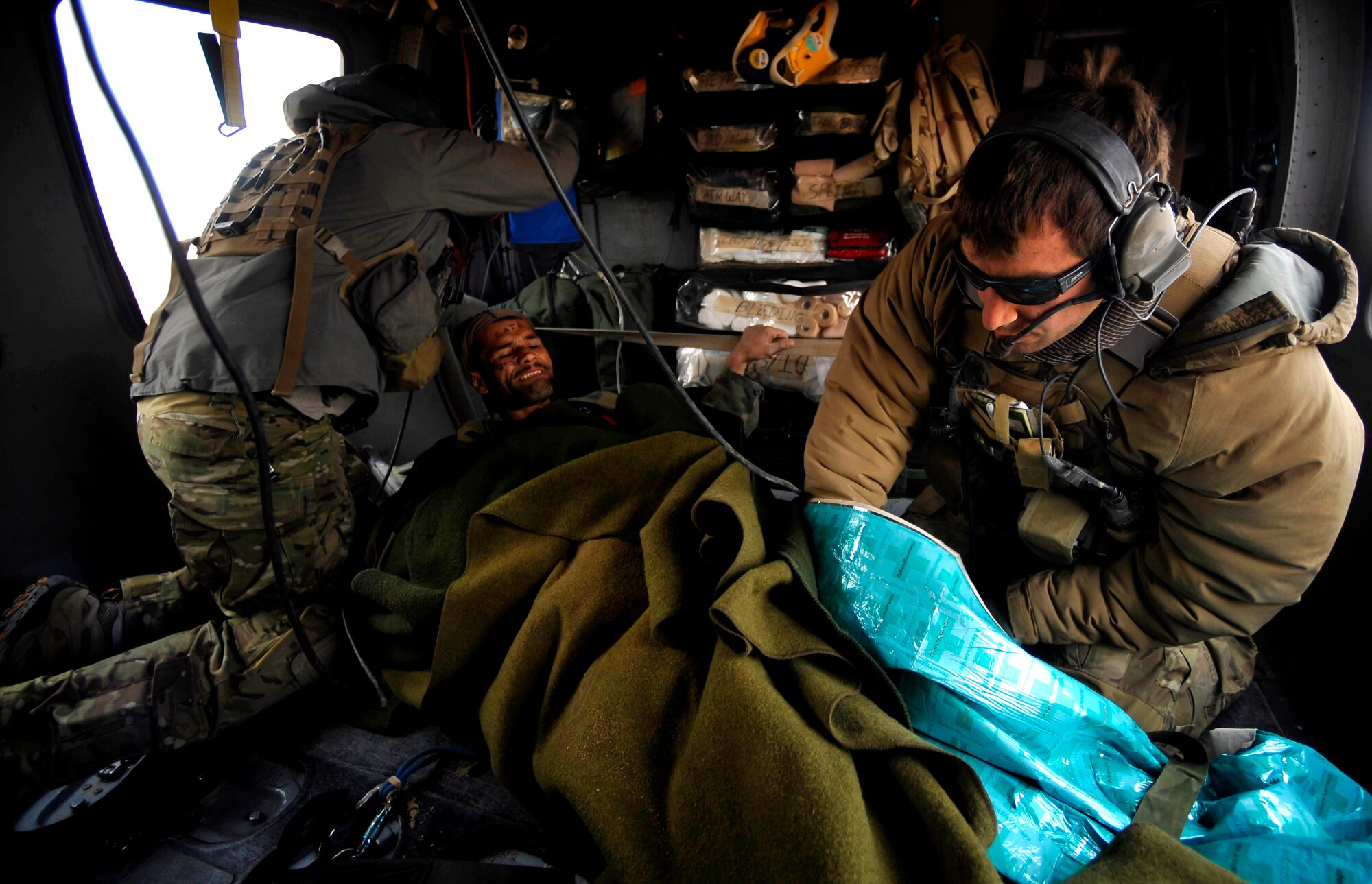 U.S. Air Force Pararescuemen from the 66th Expeditionary Rescue Squadron deployed to Camp Bastion, Afghanistan, provide medical attention to an Afghan who has suffered gunshot injuries, Dec. 08, 2009.  The PJs are able to rescue patients in any situation who need medical attention.  (U.S. Air Force photo/Staff Sgt. Angelita Lawrence)
