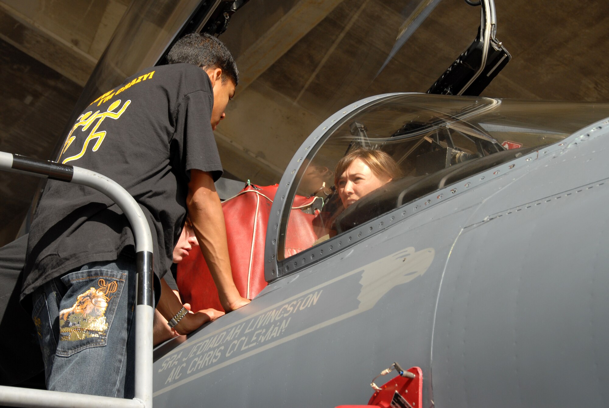 Capt. Ashley Rolfe, a pilot from the 67th Fighter Squadron, shows students from a Kadena High School physics class the cockpit of an F-15C Eagle during a “Physics in Flight” themed fieldtrip Dec. 11. The students learned how physics relates to aviation and witnessed how those theories are applied at Kadena. Besides a briefing and tour of the 67th FS jets, students also visited the 18th Aerospace Medical Squadron Physiological Training Flight and the 18th Operations Support Squadron Radar Approach Control. (U.S. Air Force photo/Staff Sgt. Kenya Shiloh)