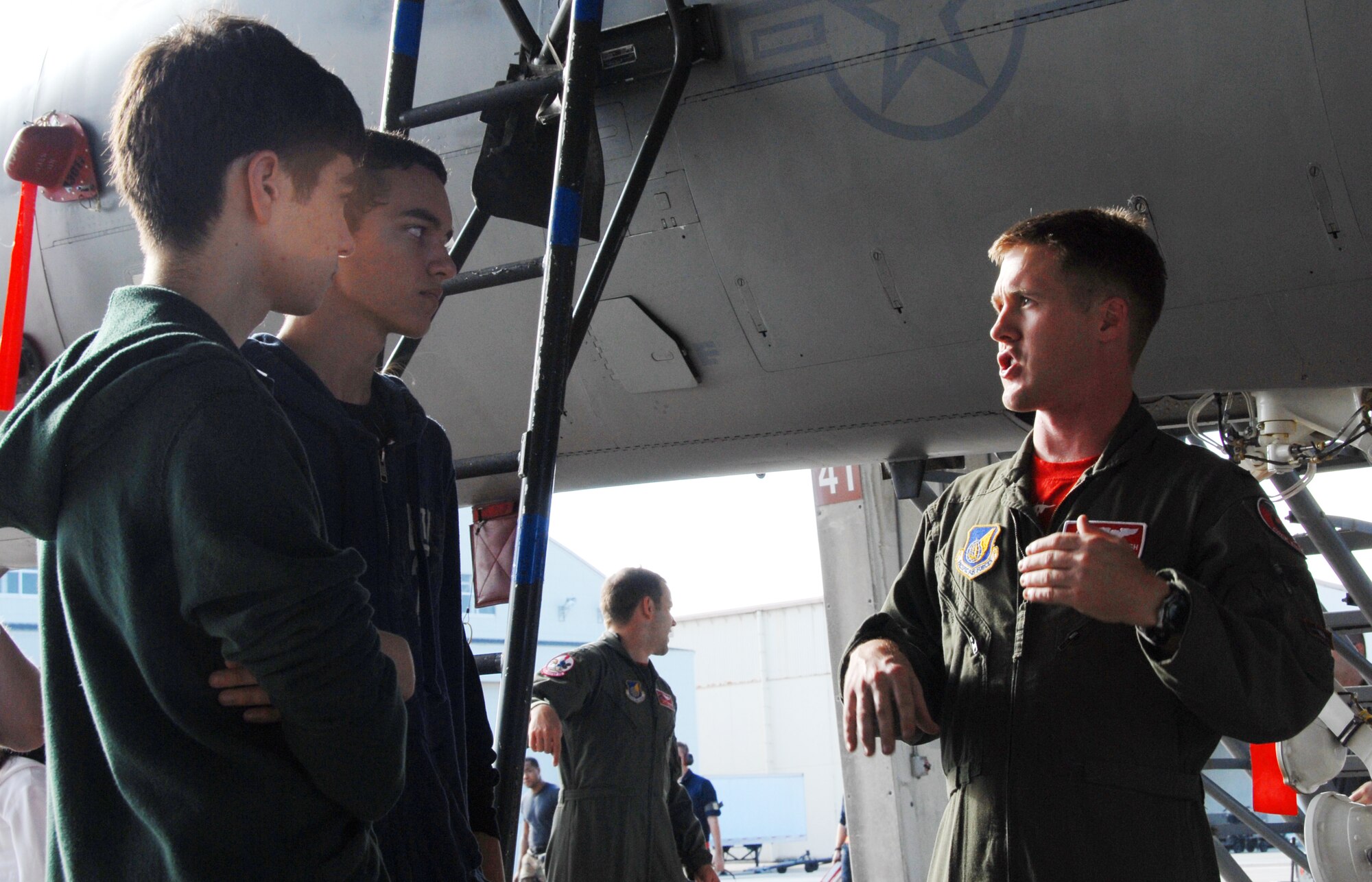 1st Lt. Daniel Parrish, 67th Fighter Squadron, highlights features of an F-15C Eagle to Kadena High School students during a physics class fieldtrip Dec. 11. The students learned how physics relates to aviation and witnessed how those theories are applied at Kadena. In addition to a briefing and tour of the 67th FS jets, students also visited the 18th Aerospace Medical Squadron Physiological Training Flight and the 18th Operations Support Squadron Radar Approach Control. (U.S. Air Force photo/Staff Sgt. Kenya Shiloh)