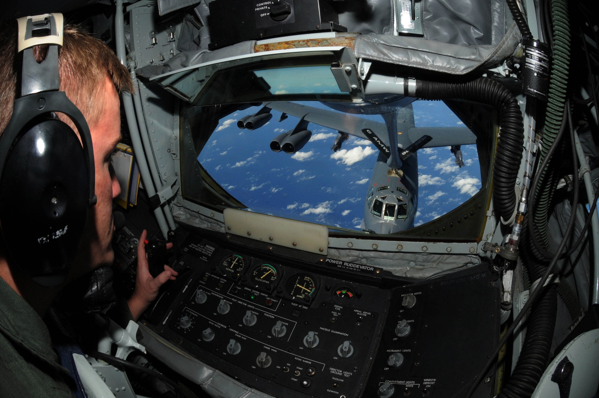 ANDERSEN AIR FORCE BASE, Guam – Tech. Sgt. Max Langford, 506th Expeditionary Air Refueling Squadron boom operator, positions the boom in order to perform an aerial refueling of a B-52 Stratofortress over the Pacific Ocean Dec. 3. Sergeant Langford was part of one of the crews that participated in Australia’s East Coast Air Defense Exercise. (U.S. Air Force photo by Airman 1st Class Julian North)