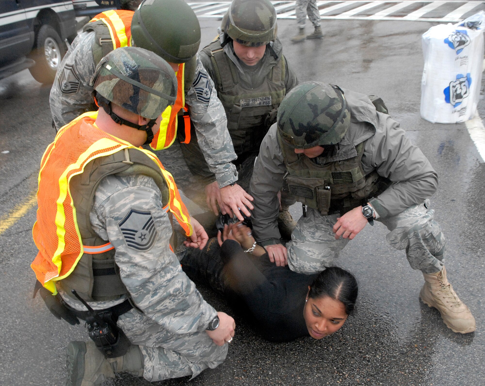 Airmen from the 51st Security Forces squadron aprehend an exercise perpetrator during an emergency management exercise here Dec. 10 at Osan Air Base, Republic of Korea. The exercise tested Osan's emergency response to situations and provided valuable training opportunities for the 51st Fighter Wing emergency response agencies. (U.S. Air Force photo/Master Sgt. Marlin Zimmerman)
