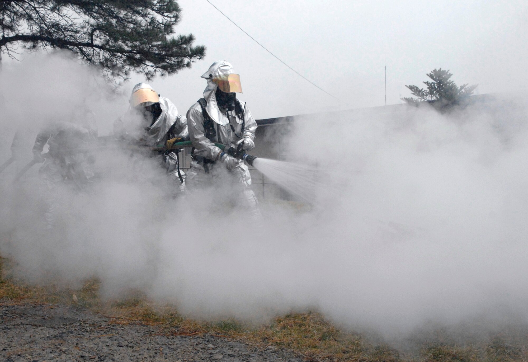 Firefighters from the 51st Civil Engineering Squadron douse a fire during an emergency management exercise here Dec. 10 at Osan Air Base, Republic of Korea. The exercise tested Osan's emergency response to situations and provided valuable training opportunities for the 51st Fighter Wing emergency response agencies. (U.S. Air Force photo/Master Sgt. Marlin Zimmerman)