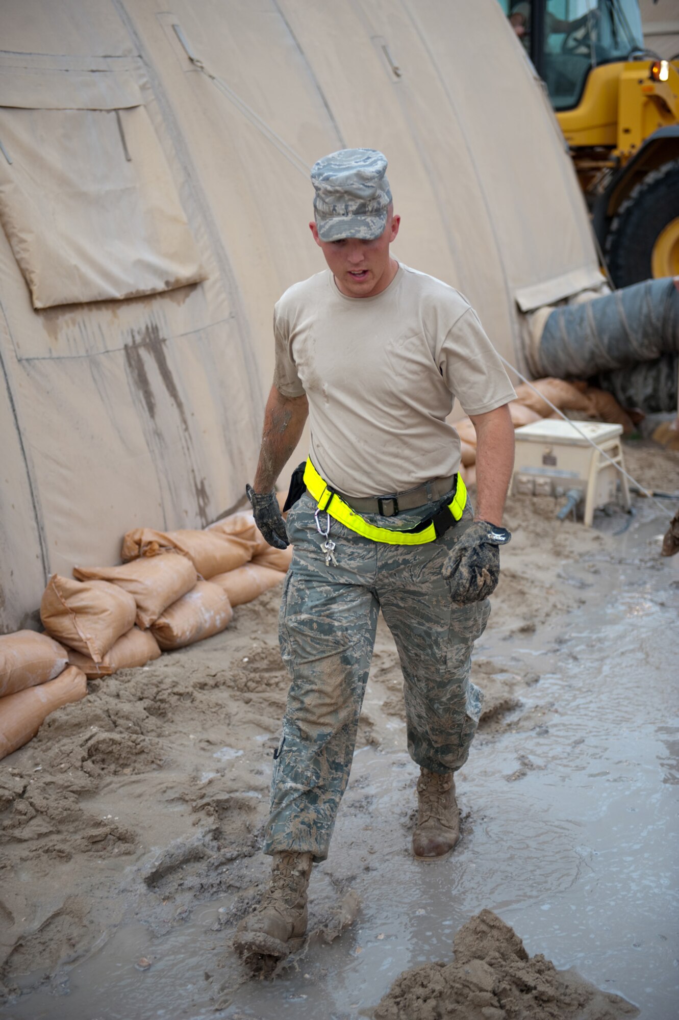 Airman 1st Class Joshua Smith, 379th Expeditionary Civil Engineer Squadron, helps replace sandbags in a common living area in Southwest Asia, Dec. 11, 2009. Airman Smith and other volunteers are filling and replacing sandbags in preparation for potential flooding to common living areas here. (U.S. Air Force photo/Staff Sgt. Robert Barney) 