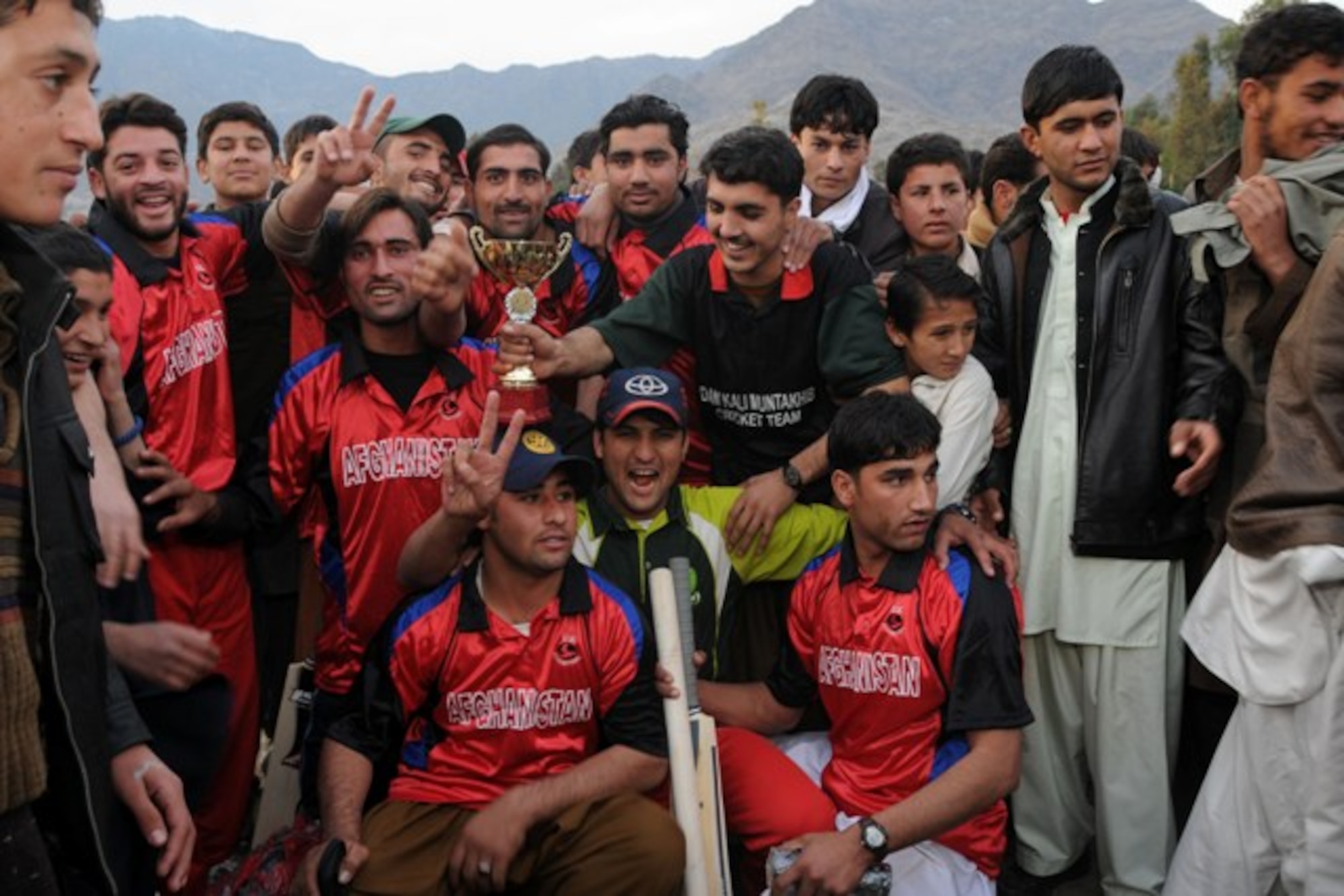 KUNAR PROVINCE, Afghanistan - The Kerala Eagles display their pride and sportsmanship after their strong, but losing, performance in an exhibition cricket match to promote peace and youth sports in Kunar province, Dec. 11. More than 400 adults and children gathered on a cool afternoon in downtown Asadabad, Afghanistan, to watch the Dam Kalay Tigers defeat the Eagles. U.S. Navy Cmdr. Leonard Remias, Kunar Provincial Reconstruction Team commander, said the match was part of the ongoing effort to engage different segments of the population.  (U.S. Air Force photo/Tech. Sgt. Brian Boisvert)