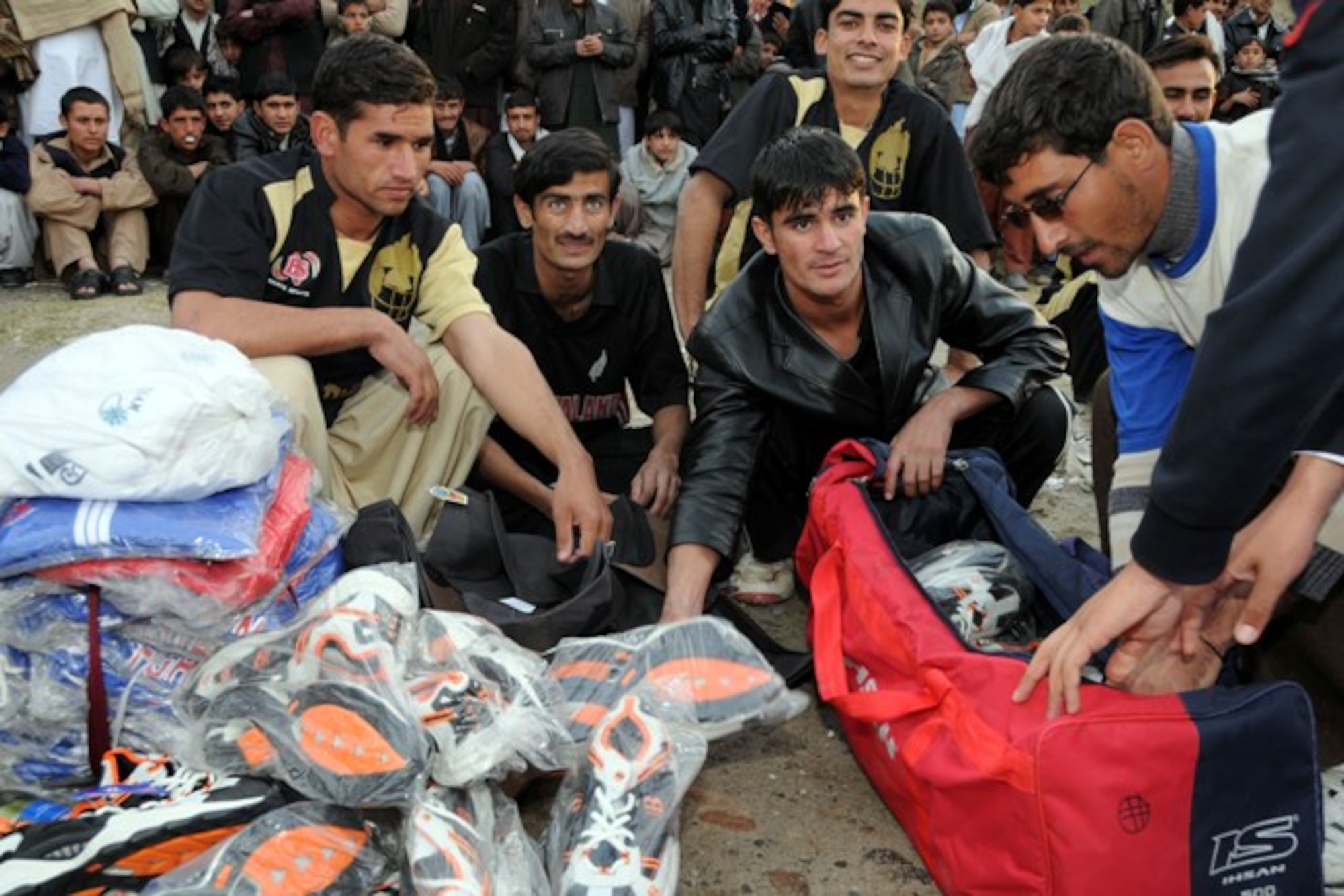 KUNAR PROVINCE, Afghanistan - The Dam Kalay Tigers receive their winner’s gifts and trophies after an exhibition cricket match to promote peace and youth sports in Kunar province, Dec. 11. More than 400 adults and children gathered on a cool afternoon in downtown Asadabad, Afghanistan, to watch the Tigers defeat the Kerala Eagles. U.S. Navy Cmdr. Leonard Remias, Kunar Provincial Reconstruction Team commander, said the match was part of the ongoing effort to engage different segments of the population. (U.S. Air Force photo/Tech. Sgt. Brian Boisvert)