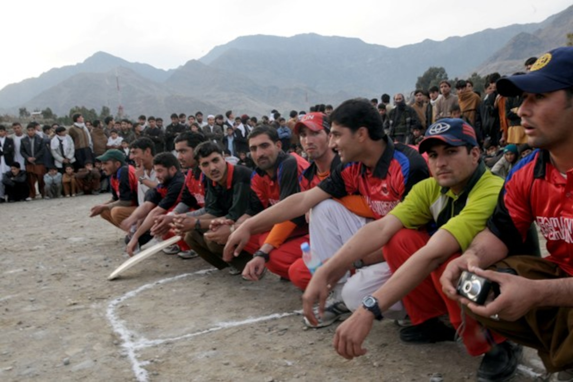 KUNAR PROVINCE, Afghanistan - The Kerala Eagles prepare to receive their second place gifts after an exhibition cricket match to promote peace and youth sports in Kunar province, Dec. 11. More than 400 adults and children gathered on a cool afternoon in downtown Asadabad, Afghanistan, to watch the Dam Kalay Tigers defeat the Eagles. U.S. Navy Cmdr. Leonard Remias, Kunar Provincial Reconstruction Team commander, said the match was part of the ongoing effort to engage different segments of the population. (U.S. Air Force photo/Tech. Sgt. Brian Boisvert)