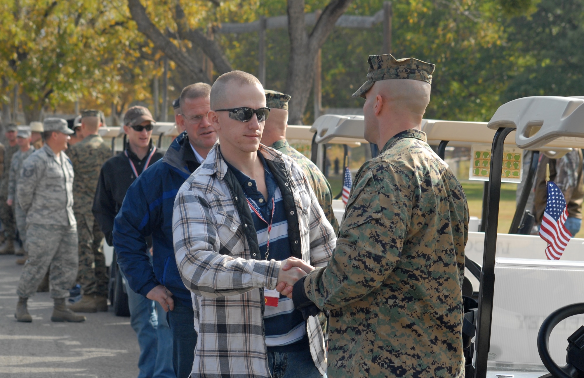 Marine Staff Sgt. Benjamin Clark from Goodfellow AFB, Texas, meets Lance Corporal Matthew McSweeney, a wounded warrior, as they prepare to drive in the annual Hunt for Heroes parade through San Angleo on Nov. 20.  25 wounded veterans took part in the annual Hunt for Heroes event in West Texas, hosted by the Show of Support Military Hunt Inc., a nonprofit organization.  The criteria for the hunt are the veterans have to be wounded or disfigured and discharged from the military. (U.S. Air Force photo/Robert D. Martinez)