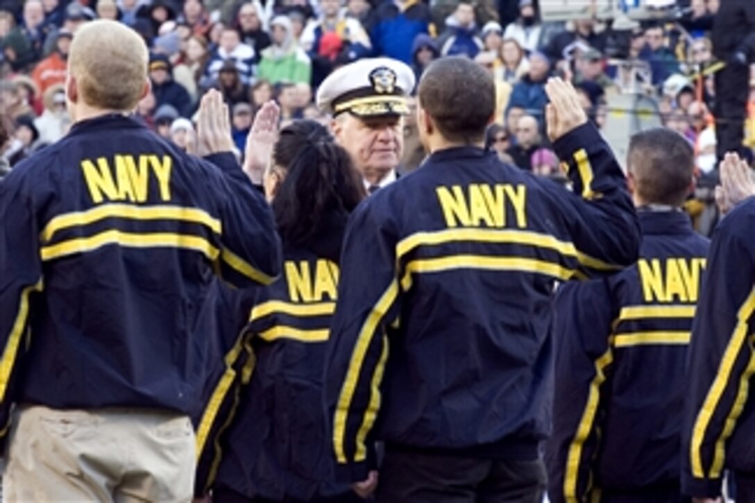 Chief of Naval Operations Adm. Gary Roughead administers the oath of office to Navy recruits during the 110th Army vs. Navy football game at Lincoln Financial Field, Philadelphia, Pa., on Dec. 12, 2009.  The game between Army and Navy is one of the oldest football rivalries and Navy has won the last seven games in a row.  Today Navy once again defeated Army with a final score of 17-3.  