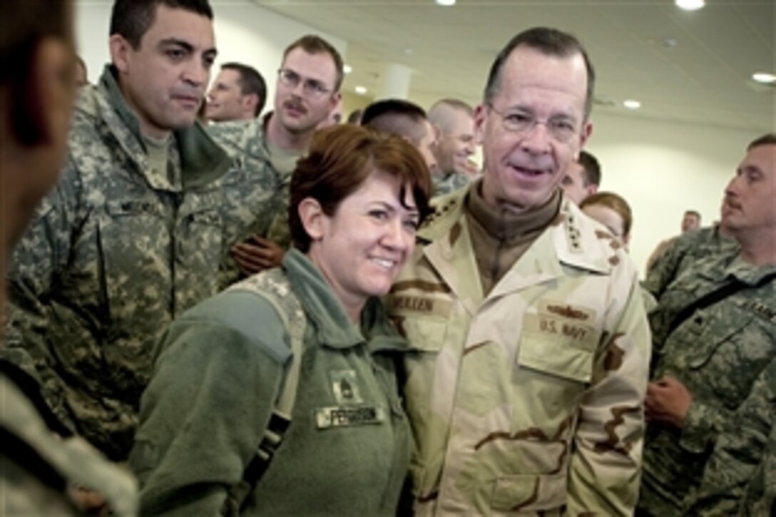 U.S. Navy Adm. Mike Mullen, chairman of the Joint Chiefs of Staff, poses for photos with soldiers in Kabul, on the 2009 USO Holiday Troop Visit, Dec. 14, 2009. 