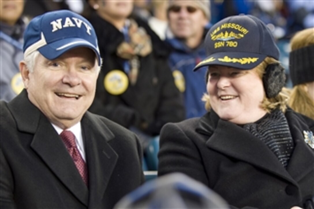 Secretary of Defense Robert M. Gates and his wife Becky watch the second half of the game from the Navy side of the field during the 110th Army vs. Navy football game at Lincoln Financial Field, Philadelphia, Pa., on Dec. 12, 2009.  Gates wore a Navy hat and Becky wore a hat from the USS Missouri (SSN-780), a submarine that she christened last weekend in Groton, Conn.  