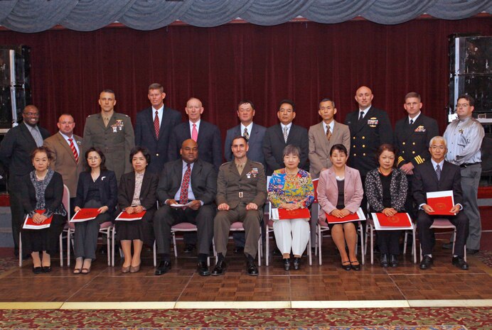 U.S. Forces Japan employees pose for a group picture after a retirement ceremony at the Club Iwakuni Ballroom here Dec. 14. With over 30 years of service: Kenji Nagahama, Hitomi Yamaguchi, Tetsuei Yamada, Tetsuro Nomura, Shiro Morishige, and Masao Hamashige. With over 20 years of service: Hiroshi Yamamoto, Kuniko Kikuchi, Yasuhiro Seiji, Mikio Kurisu, and Aki Yasuda. With over 10 years of service: Kyoto Ito, Kiyoko Maruyama, Toshiko Tomita, Junko Komoto, and Fusae Matsumura.