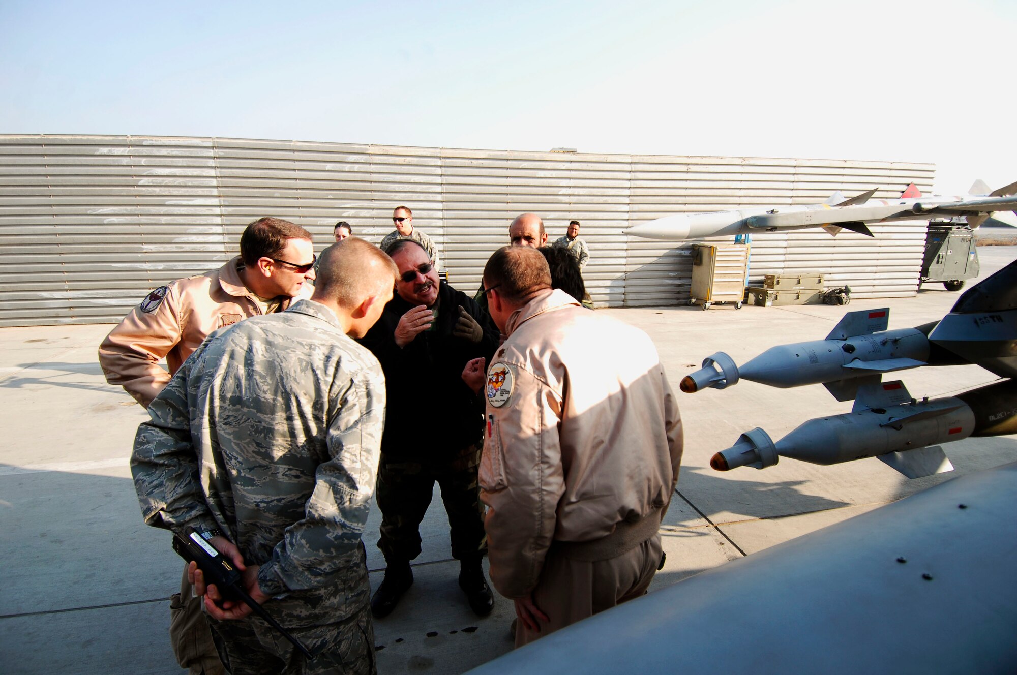 BAGRAM AIRFIELD - Afghan National Army Air Corps Brig. Gen. Abdul Wahab Wardak discusses Afghan and Coalition flying operations with a group of U.S. Air Force officers on the flightline here, Dec. 19, 2009.  General Wardak and a delegation of Afghan National Army Air Corps officials visited with the 455th Air Expeditionary Wing to discuss Close Air Support operations, Air Traffic Control, Maintenance, weapons loading procedures and cargo processing procedures.  (U.S. Air Force photo/Capt. David Faggard)
