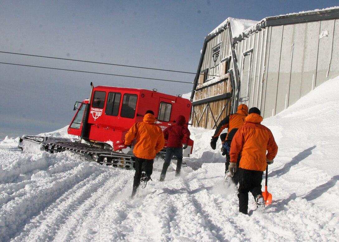 MT. HOOD, Ore. - Staff Sgt. Philip Van Peursem, Tech Sgt. Richard Oberstar, Master Sgt. Derrick Brooks,  Staff Sgt. Ian Jameison run to finish digging out the snowed in shed that will serve as their base of operations during search efforts on Mount Hood. Once inside the pararescumen positioned equipment for several potential scenarios. (U.S. Air Force Photo/Senior Airman Adam Hoffmann)