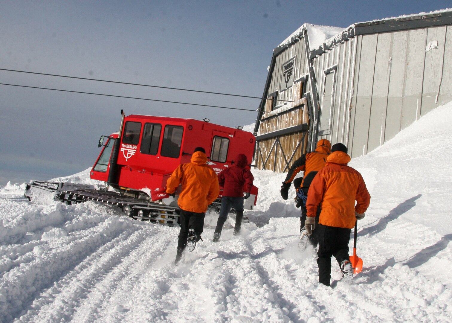 MT. HOOD, Ore. - Staff Sgt. Philip Van Peursem, Tech Sgt. Richard Oberstar, Master Sgt. Derrick Brooks,  Staff Sgt. Ian Jameison run to finish digging out the snowed in shed that will serve as their base of operations during search efforts on Mount Hood. Once inside the pararescumen positioned equipment for several potential scenarios. (U.S. Air Force Photo/Senior Airman Adam Hoffmann)