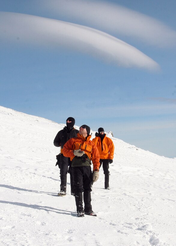 MT. HOOD, Ore. -  - Staff Sgt. Ian Jameison, Master Sgt. Derrick Brooks,  and Staff Sgt. Philip Van Peursem configure their GPS devices and discuss the incoming weather. This type of search and rescue is not new to the  304th Rescue Squadron, the Air Force Reserve pararescuemen are trained in cold weather searches and medical evacuations.(U.S. Air Force Photo/Senior Airman Adam Hoffmann)
