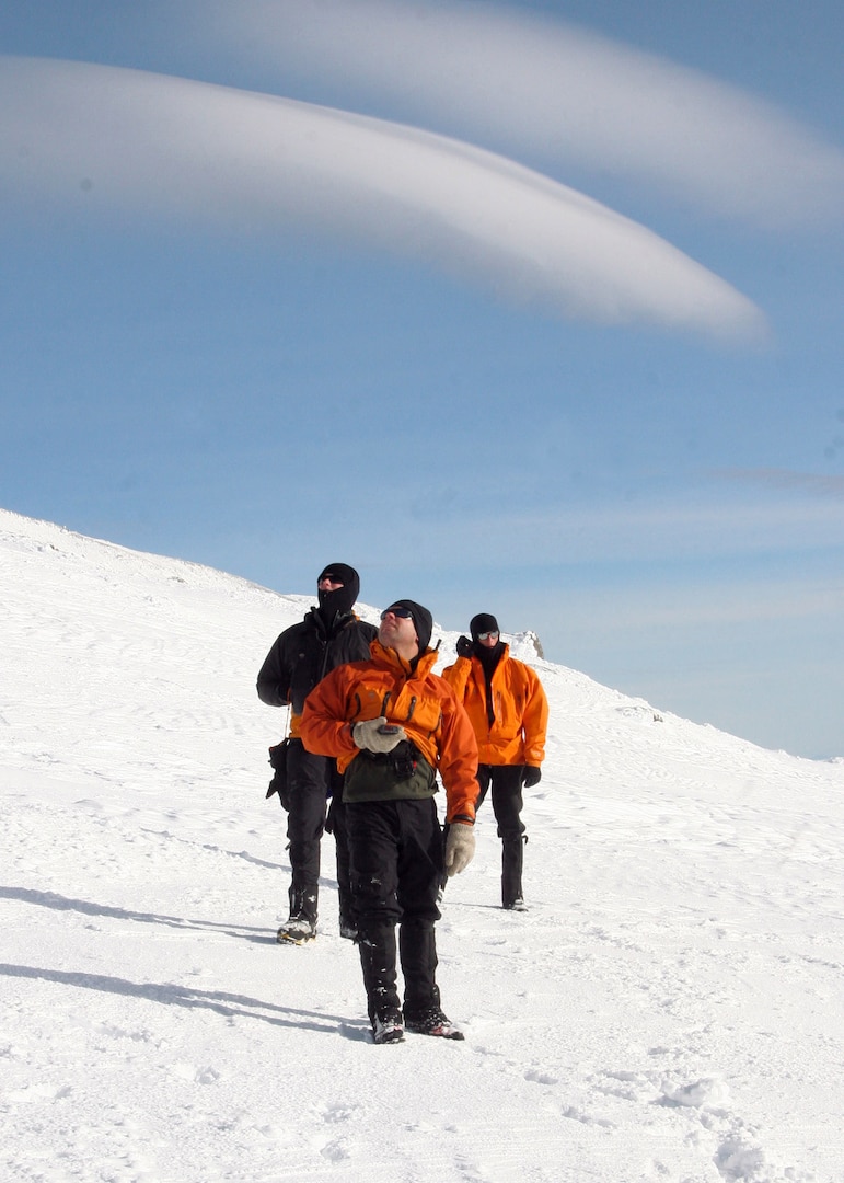 MT. HOOD, Ore. -  - Staff Sgt. Ian Jameison, Master Sgt. Derrick Brooks,  and Staff Sgt. Philip Van Peursem configure their GPS devices and discuss the incoming weather. This type of search and rescue is not new to the  304th Rescue Squadron, the Air Force Reserve pararescuemen are trained in cold weather searches and medical evacuations.(U.S. Air Force Photo/Senior Airman Adam Hoffmann)
