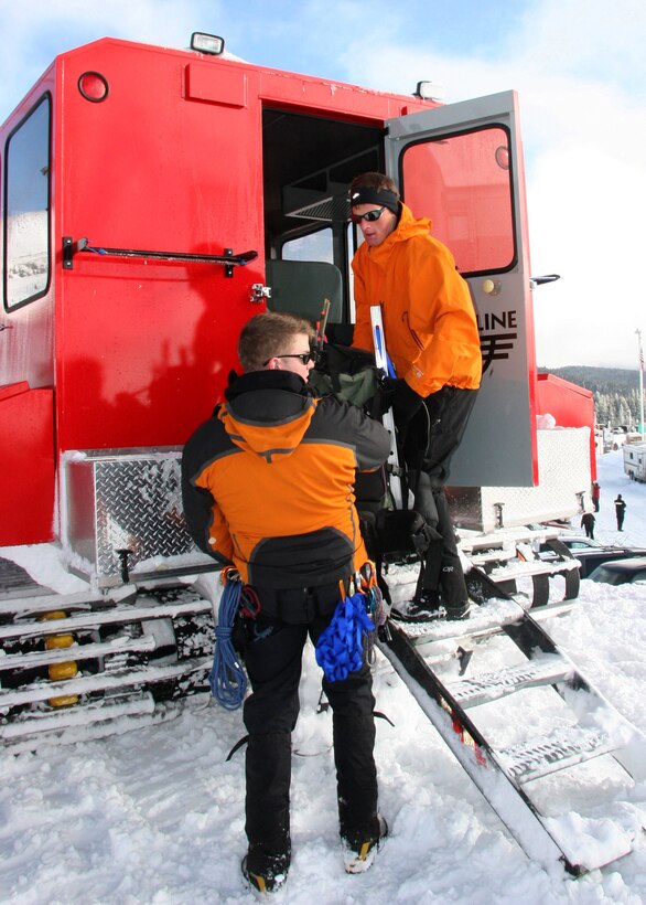 MT. HOOD, Ore - Staff Sgt. Ian Jameison and Ssgt. Philip Van Peursem load equipment into a Snow Cat preparing for their teams ascent to 7,000 ft. Once atop the mountain the team prepared an area from which they could treat the missing hikers, or injured rescuers if needed. (U.S. Air Force Photo/Senior Airman Adam Hoffmann)  
