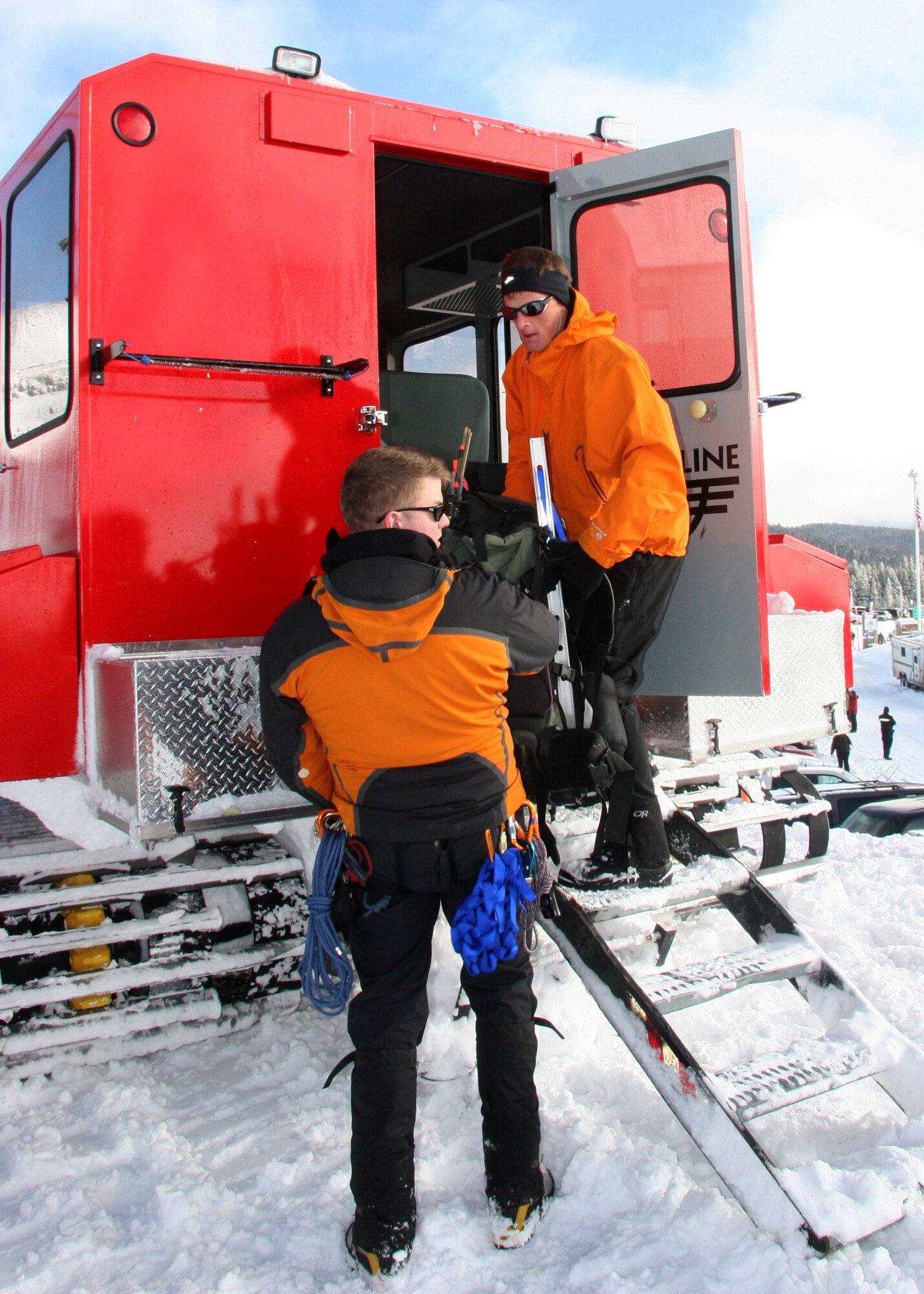 MT. HOOD, Ore - Staff Sgt. Ian Jameison and Ssgt. Philip Van Peursem load equipment into a Snow Cat preparing for their teams ascent to 7,000 ft. Once atop the mountain the team prepared an area from which they could treat the missing hikers, or injured rescuers if needed. (U.S. Air Force Photo/Senior Airman Adam Hoffmann)  
