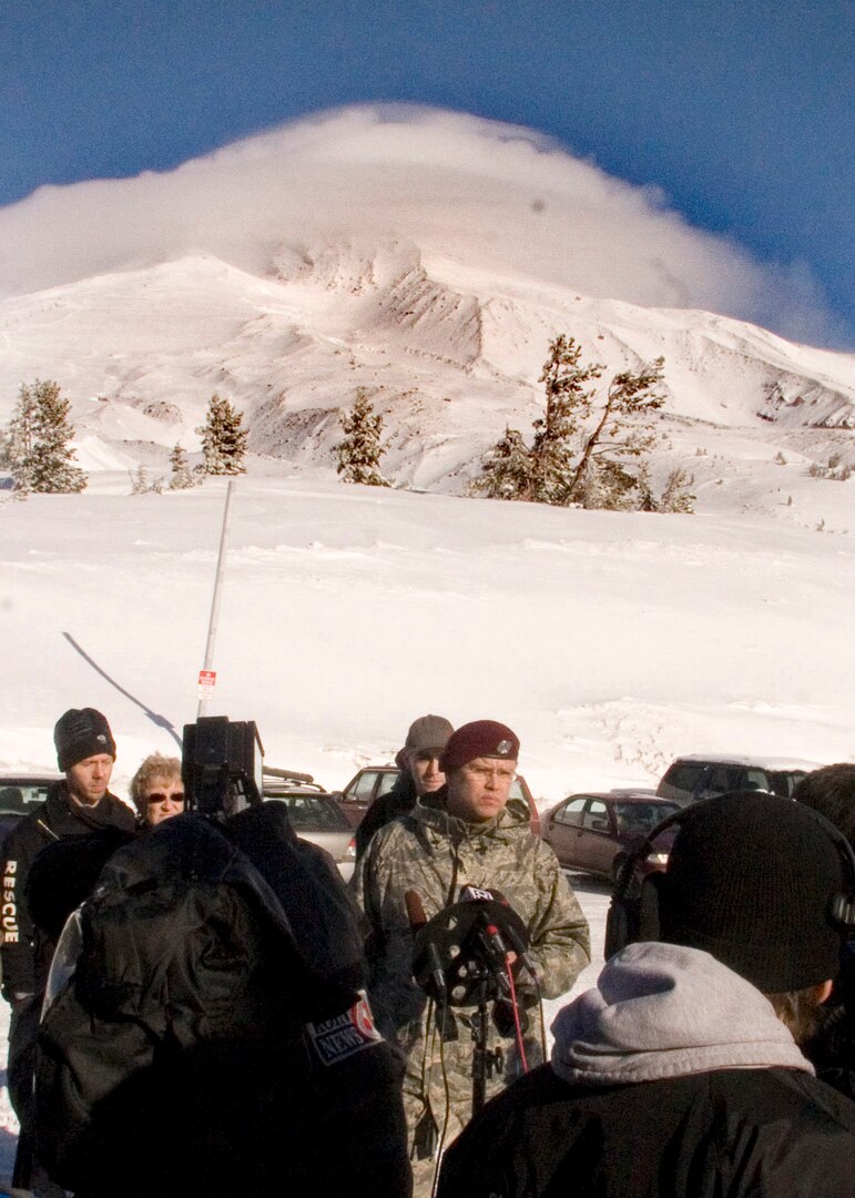 MT. HOOD, Ore. - Capt. Chris Bernard, of the 304th Rescue Squadron, participates in a press briefing as the 304th Pararescumen arrive on Mount Hood. The 304th will join other volunteers in the search for two missing hikers atop Mount Hood near Portland Oregon. The 304th has participated in rescue efforts on Mount Hood through its history. (U.S. Air Force Photo/Senior Airman Adam Hoffmann)