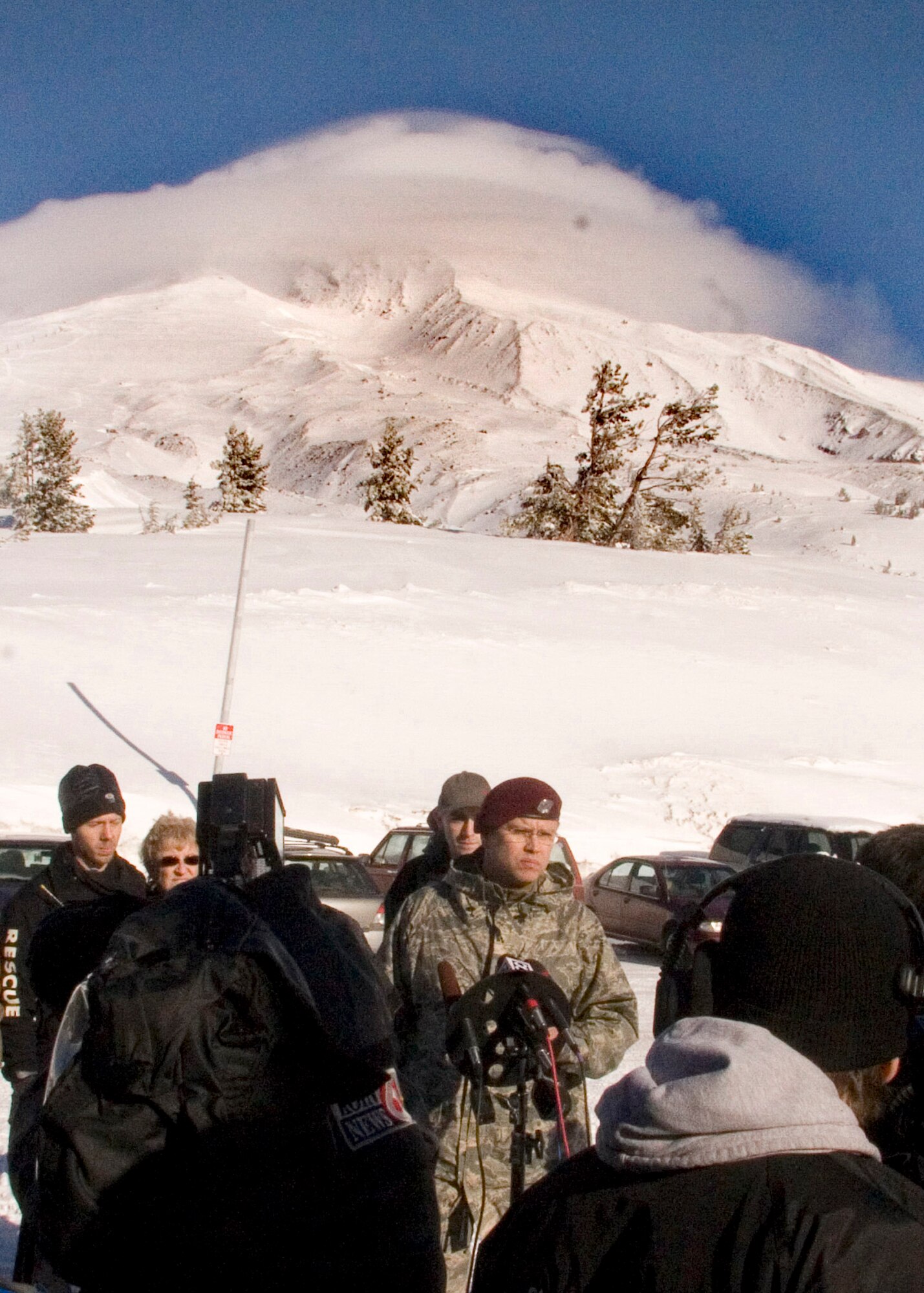 MT. HOOD, Ore. - Capt. Chris Bernard, of the 304th Rescue Squadron, participates in a press briefing as the 304th Pararescumen arrive on Mount Hood. The 304th will join other volunteers in the search for two missing hikers atop Mount Hood near Portland Oregon. The 304th has participated in rescue efforts on Mount Hood through its history. (U.S. Air Force Photo/Senior Airman Adam Hoffmann)